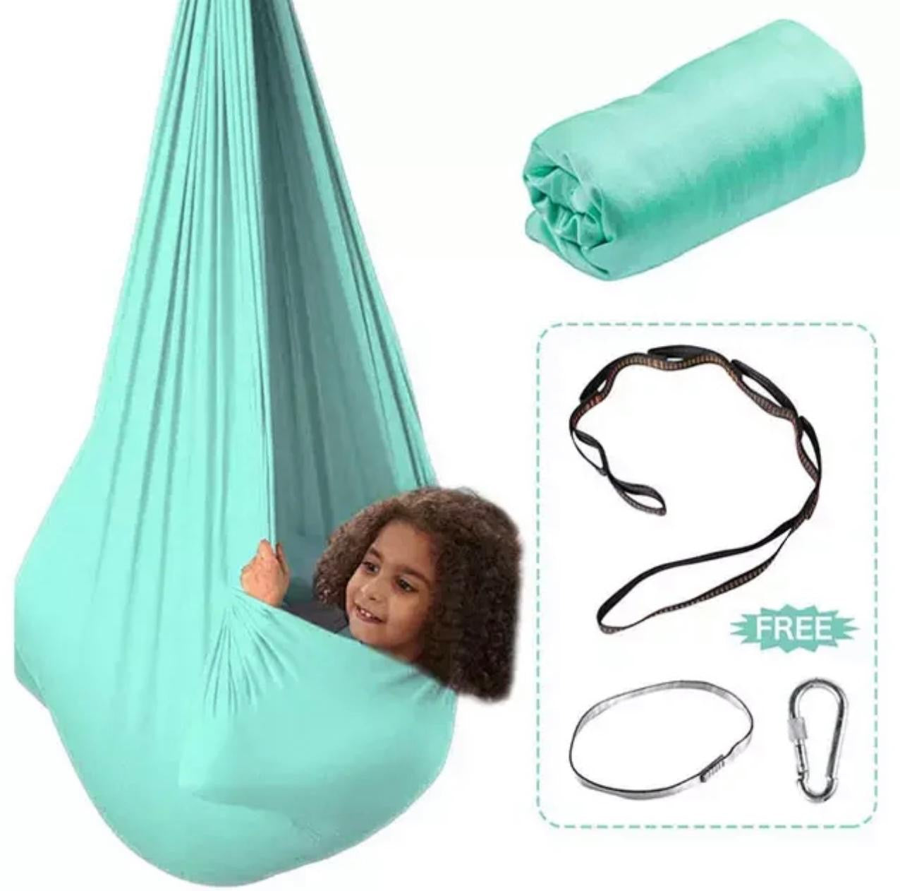 Child resting inside a hanging therapy swing pod – promoting relaxation, focus, and gentle movement in a home or therapeutic environment.