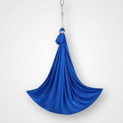 A blue therapy swing pod made of soft, stretchable fabric, hanging from a ceiling attachment. Therapy swing pod hanging from frame – cocoon-style swing designed to support calm, balance, and emotional regulation at home or in care settings.