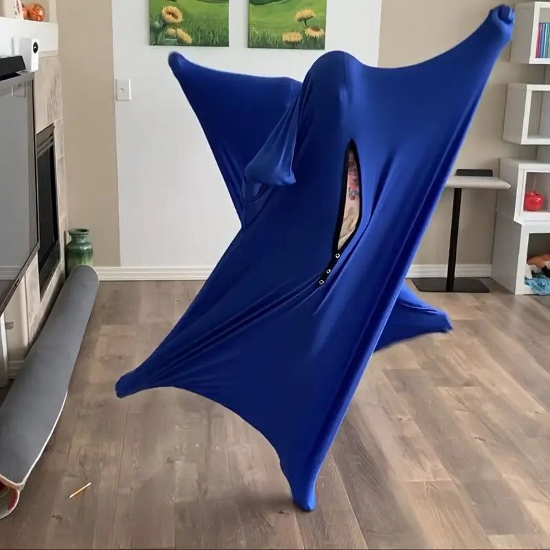 A blue lycra sock designed for sensory play, displayed in a room setting. Child inside a soft, stretchy body sock – promoting active play, spatial awareness, and emotional balance through gentle resistance.